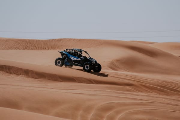 Dune buggy speeding across sand dunes on an off-road adventure