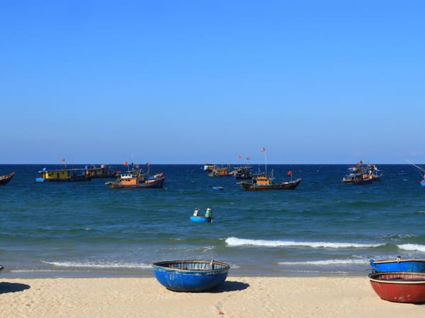 Colorful fishing boats on a sunny coastal shore