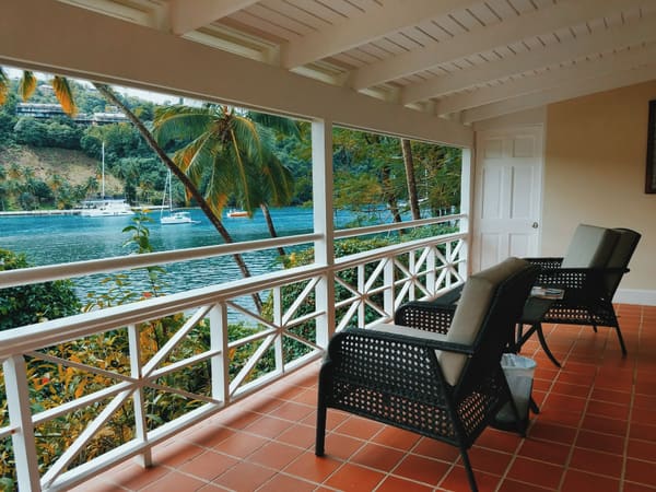 Tropical resort balcony with palm trees overlooking the ocean