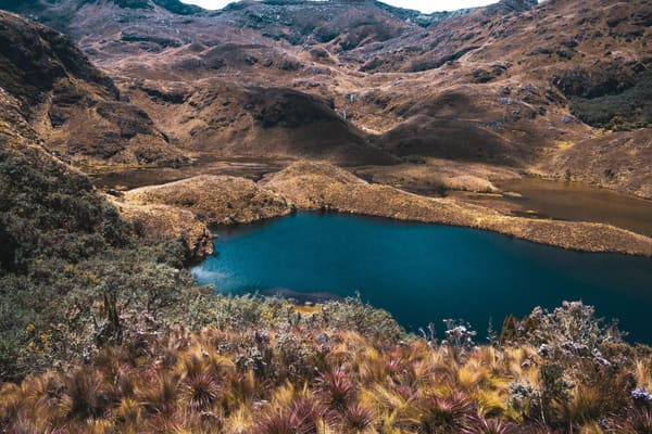 Lake below brown mountains from a high vantage point