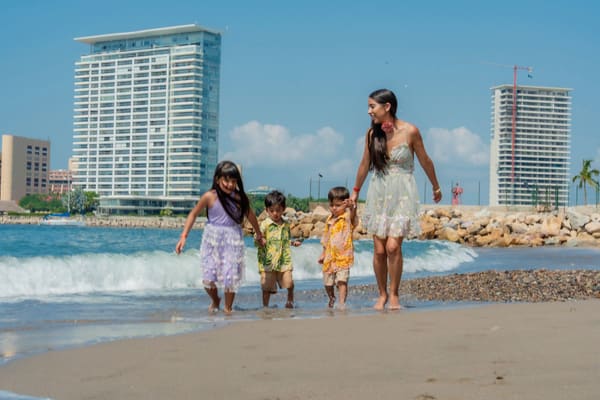 Family with kids playing on a sunny beach